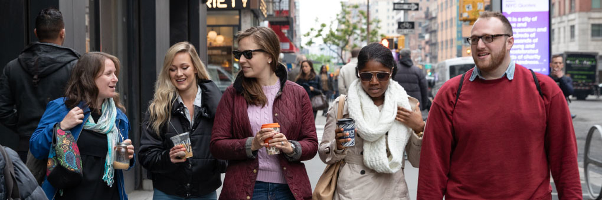 Michelle Kedem walks and talks with four On-Ramps coworkers.